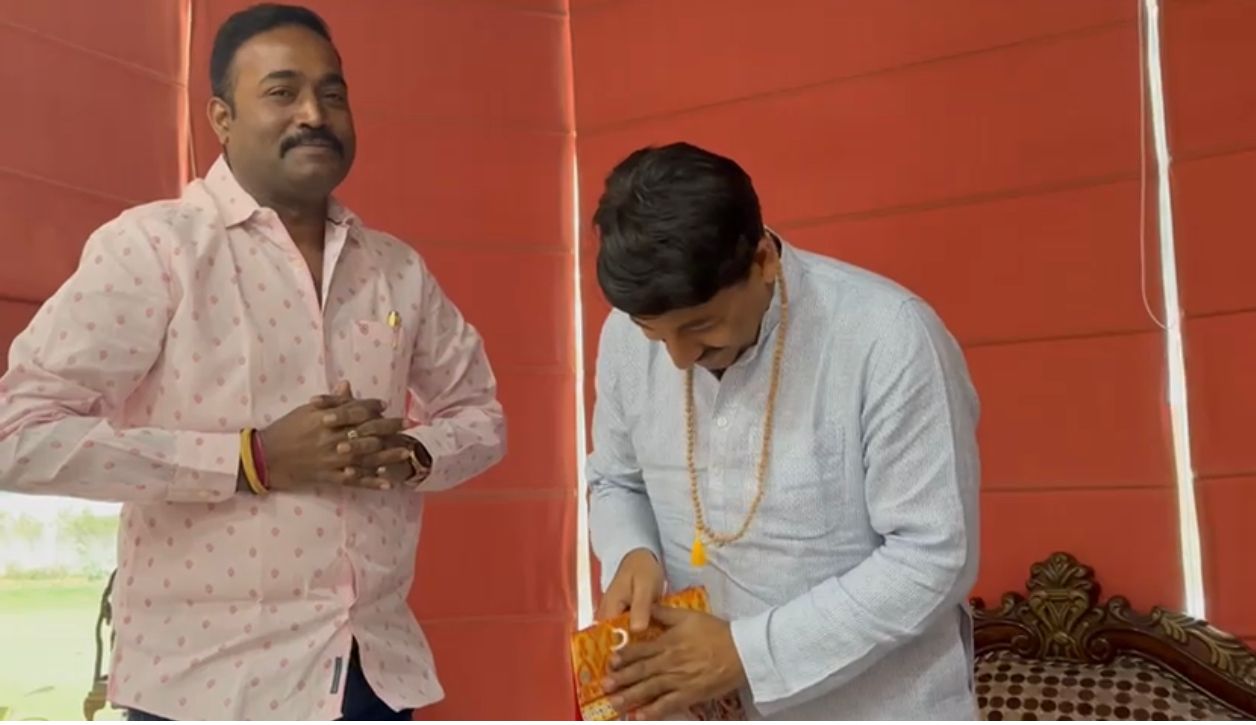Presenting Book to MP Manoj Tiwari